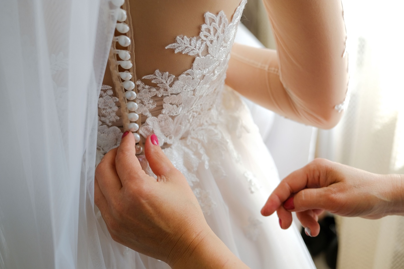 Buttoning a lace gown