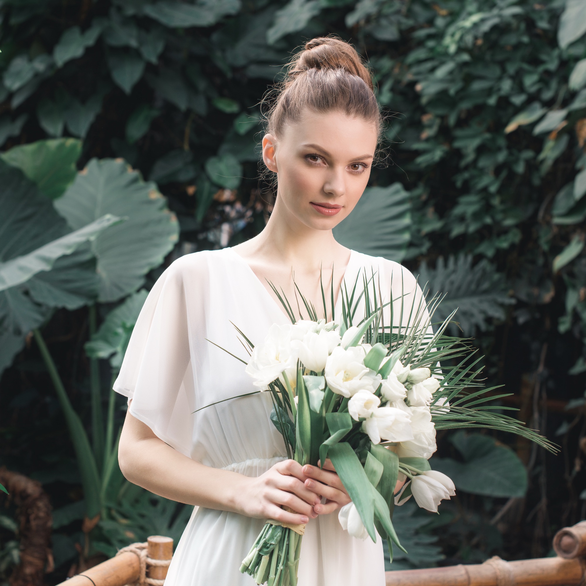 Bride holding a bouquet of white flowers